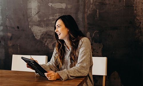 woman smiles at office table